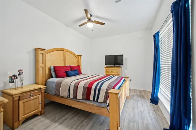 a bedroom with a bed and wooden floor