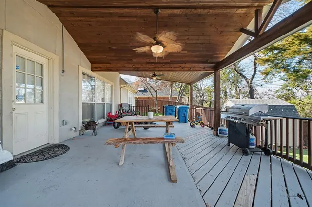 a view of a patio with table and chairs and wooden floor