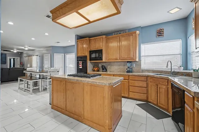 a kitchen with stainless steel appliances granite countertop a sink and cabinets