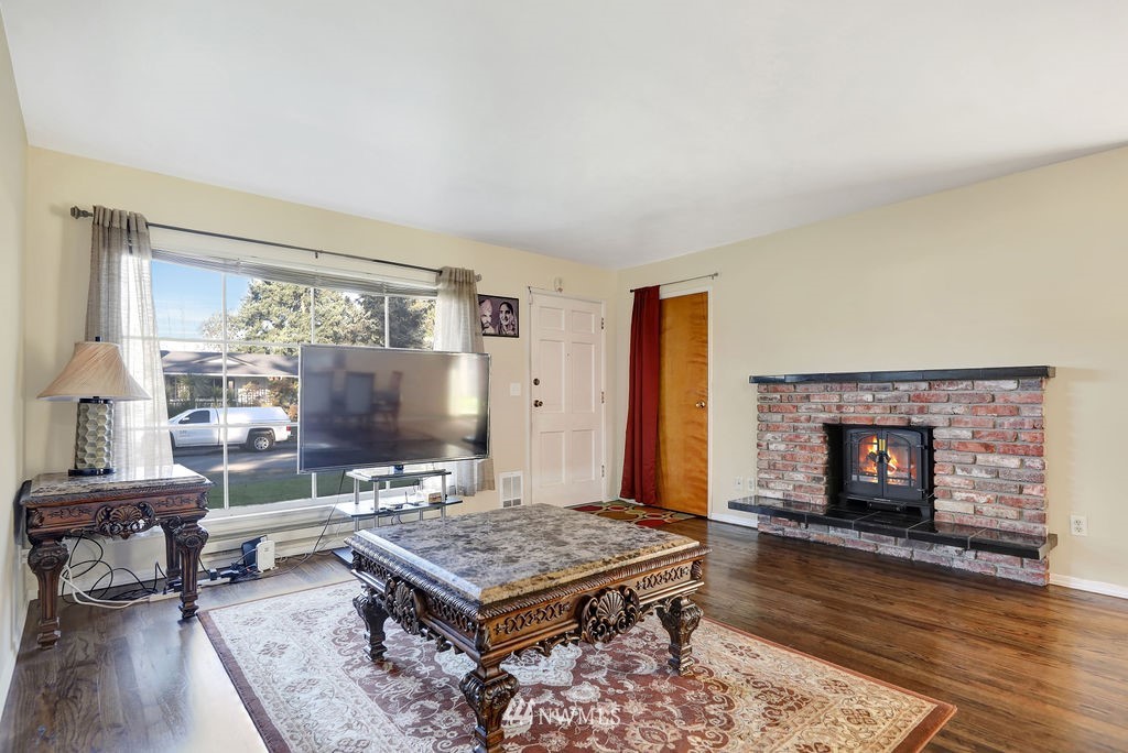4107 Northeast 10th Street Renton, WA 98059 - Photo 3 of 33 a living room with furniture and a fireplace