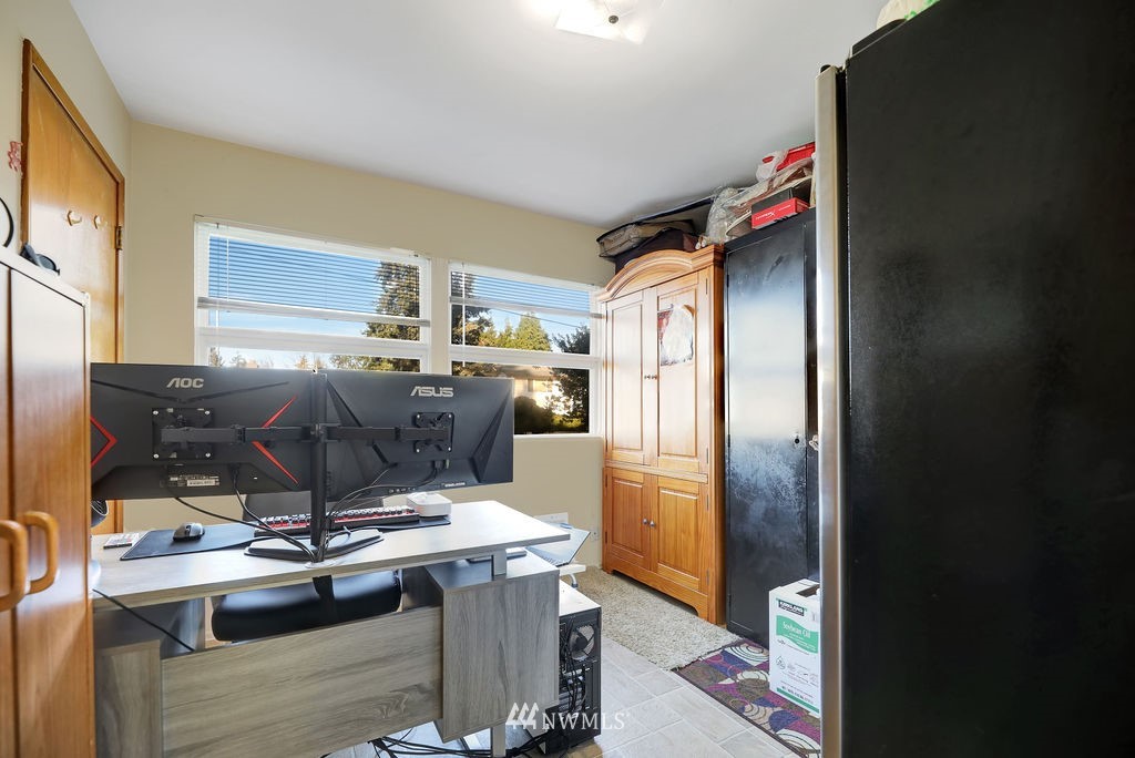 4107 Northeast 10th Street Renton, WA 98059 - Photo 22 of 33 a room with stainless steel appliances kitchen island granite countertop a refrigerator and a stove