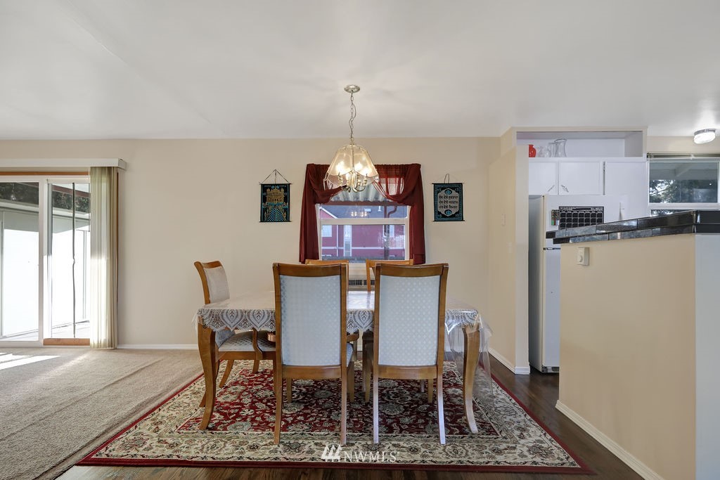 4107 Northeast 10th Street Renton, WA 98059 - Photo 5 of 33 a dining room with furniture a rug and a chandelier