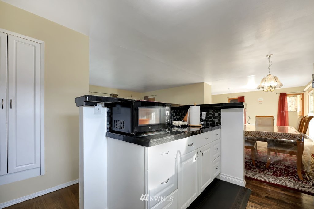 4107 Northeast 10th Street Renton, WA 98059 - Photo 8 of 33 a kitchen with stainless steel appliances a microwave sink and cabinets