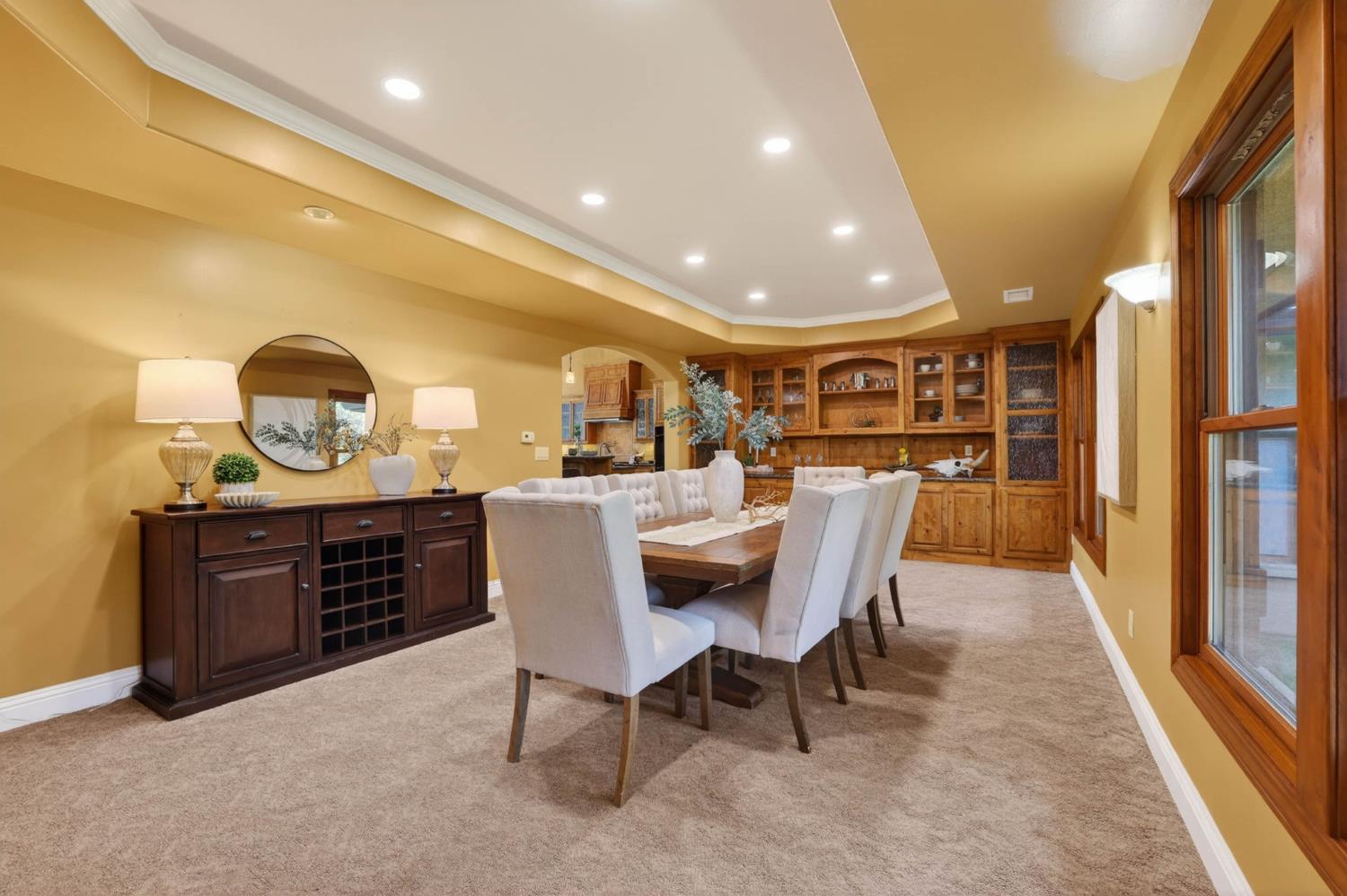 7021 Horseshoe Bar Road Loomis, CA 95650 - Photo 14 of 77 Spacious formal dining room with extensive custom built-ins including a large buffet, conveniently positioned just off the kitchen to create a seamless flow for hosting and entertaining.