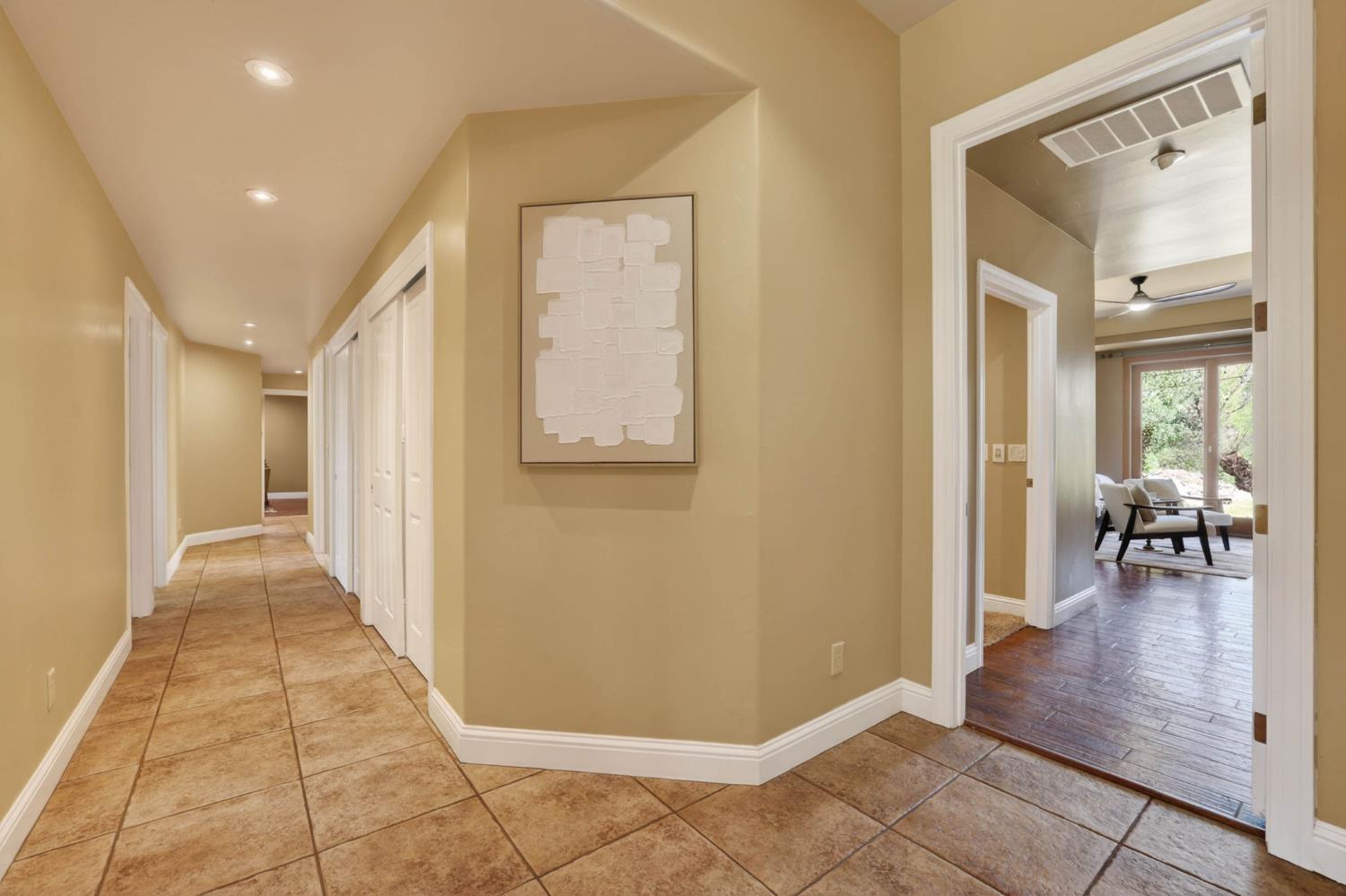 7021 Horseshoe Bar Road Loomis, CA 95650 - Photo 17 of 77 Wide hallway off the main living areas creates a natural flow, leading seamlessly to the private bedroom spaces.