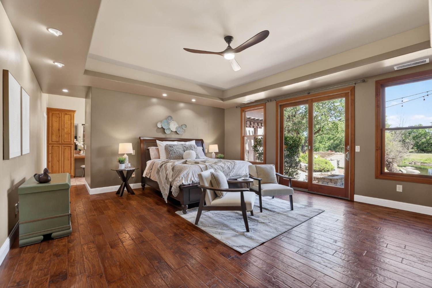 7021 Horseshoe Bar Road Loomis, CA 95650 - Photo 20 of 77 Light filled expansive primary suite with radiant heated floors, custom built-ins, coffered ceilings and can lighting, complemented by sliding glass doors for private outdoor access.