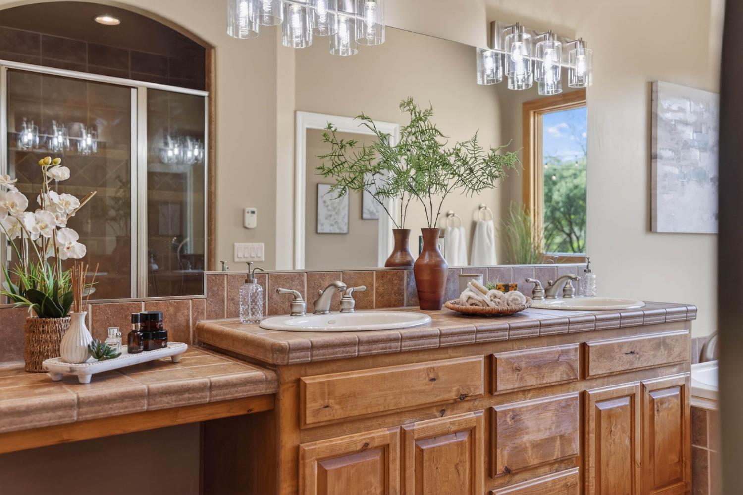 7021 Horseshoe Bar Road Loomis, CA 95650 - Photo 22 of 77 Primary bathroom showcasing a large walk-in shower with dual showerheads and a built-in bench, designed for a spa-like experience.