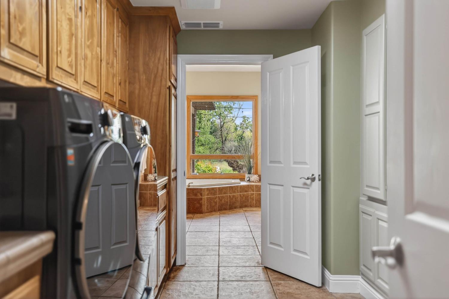 7021 Horseshoe Bar Road Loomis, CA 95650 - Photo 24 of 77 Thoughtfully designed for convenience, this laundry room offers direct access from the primary suite and connects seamlessly tot he hallway serving the additional bedrooms.