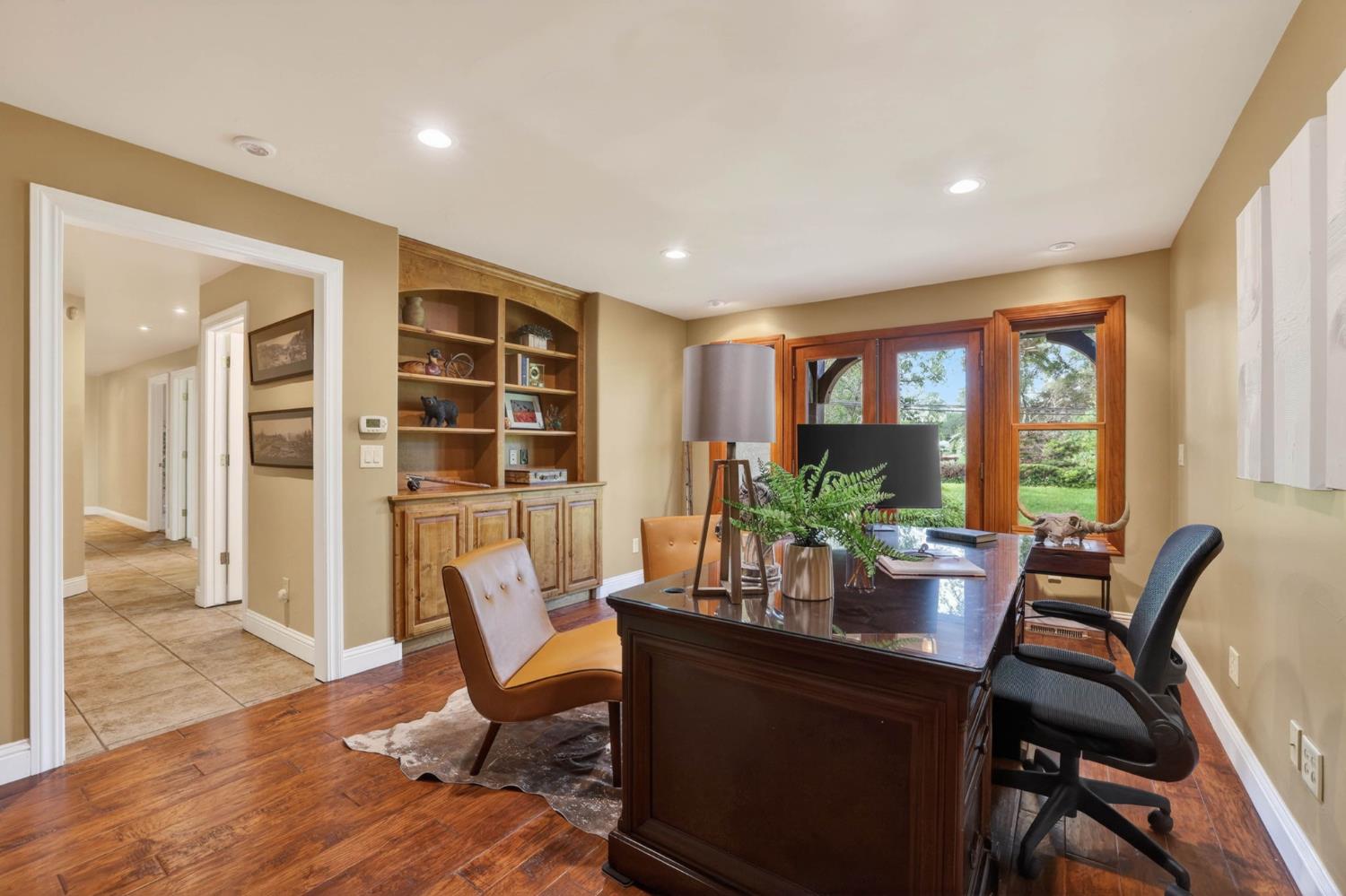 7021 Horseshoe Bar Road Loomis, CA 95650 - Photo 30 of 77 Dedicated office featuring custom built-ins, expansive windows that frame peaceful outdoor views, with outdoor access and private patio.