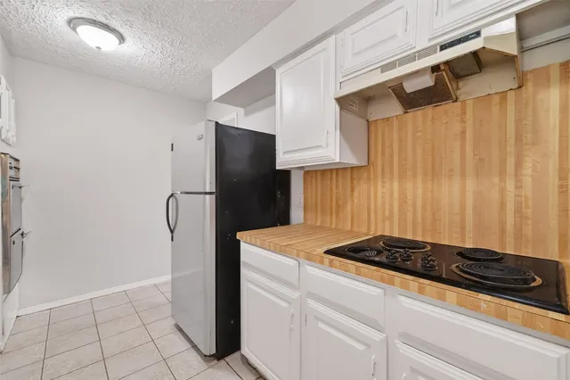 a kitchen with a refrigerator and a stove