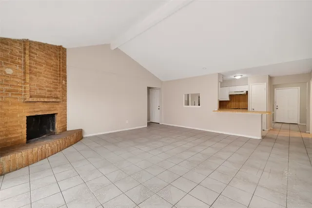 a view of an empty room with a fireplace