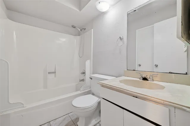 a bathroom with a sink toilet a mirror and shower