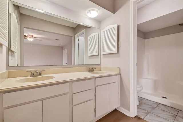 a bathroom with a double vanity sink and mirror