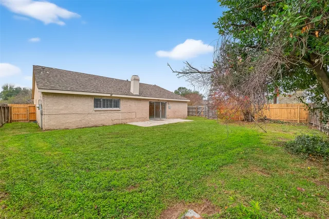 a front view of house with yard and trees