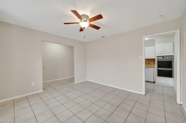 an empty room with closet and windows