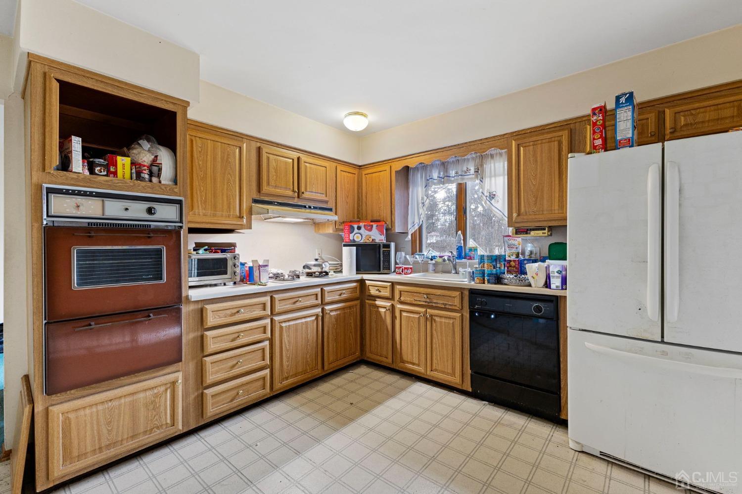 8 Mathison Place Milltown, NJ 08850 - Photo 3 of 17 a kitchen with granite countertop a refrigerator stove and sink