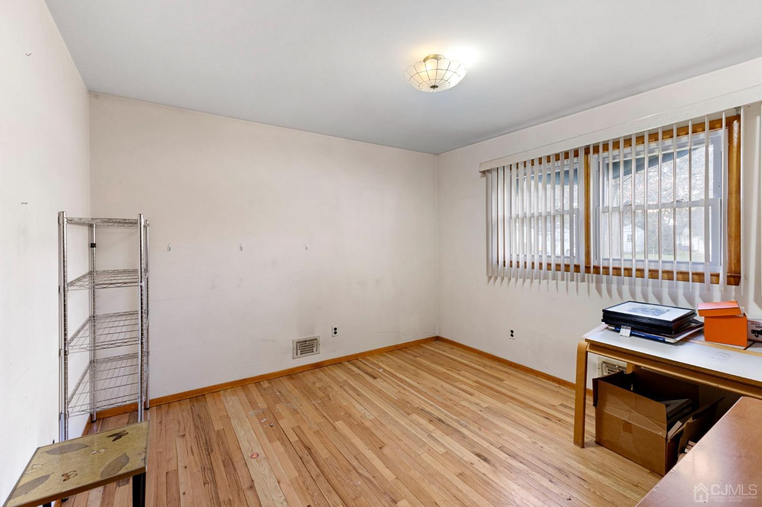 8 Mathison Place Milltown, NJ 08850 - Photo 5 of 17 wooden floor in an empty room with a window