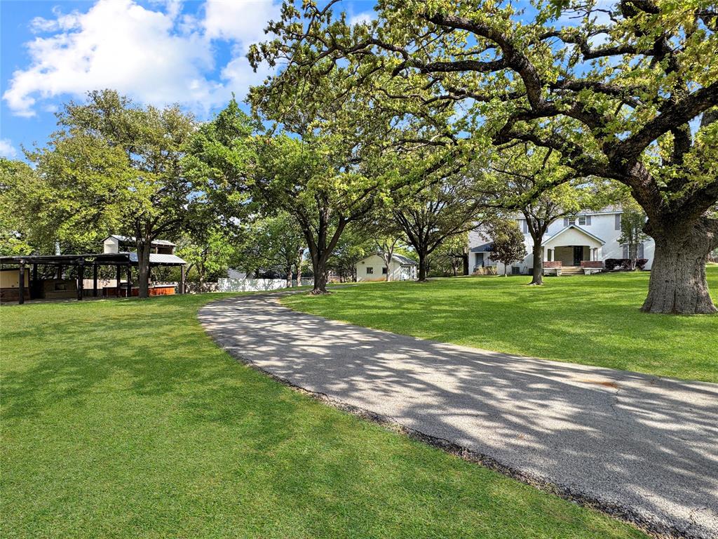 1205 Forest Ridge Drive Bedford, TX 76022 - Photo 3 of 40 Huge shade trees. Two Drive way entrances to circle drive