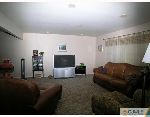 2 Lynnwood Road Edison, NJ 08820 - Photo 2 of 8 a living room with furniture and a flat screen tv