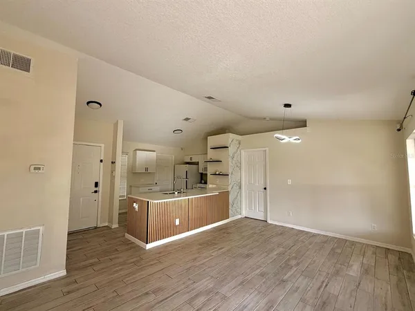 a view of a kitchen cabinets and wooden floor