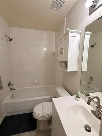 a bathroom with a sink a toilet and a bathtub