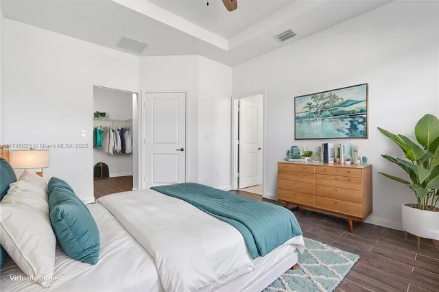 a bedroom with a bed and a painting on the wall