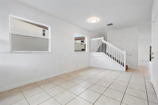 a view of a livingroom with an empty space and a window