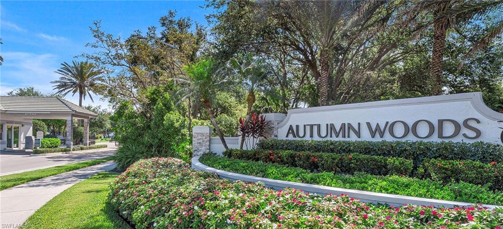 7057 Timberland Circle Naples, FL 34109 - Photo 1 of 22 a view of a street sign under a large tree