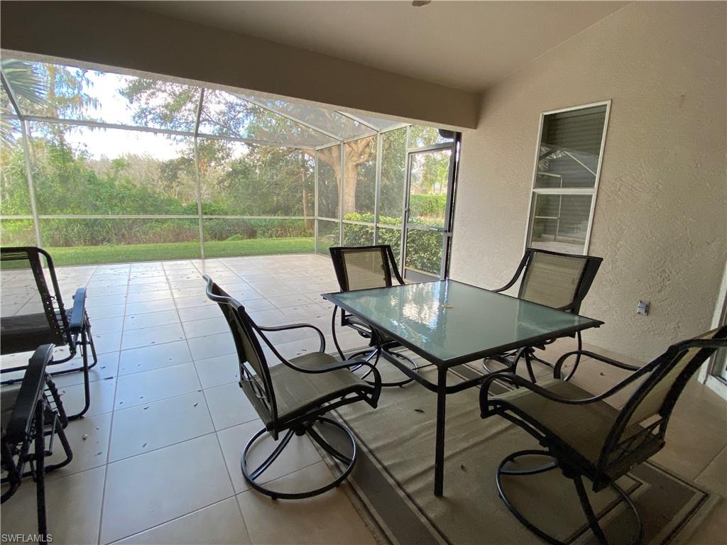 7057 Timberland Circle Naples, FL 34109 - Photo 12 of 22 a view of a chairs and table in patio