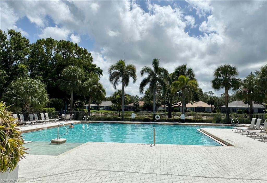 7057 Timberland Circle Naples, FL 34109 - Photo 15 of 22 a view of swimming pool with a yard