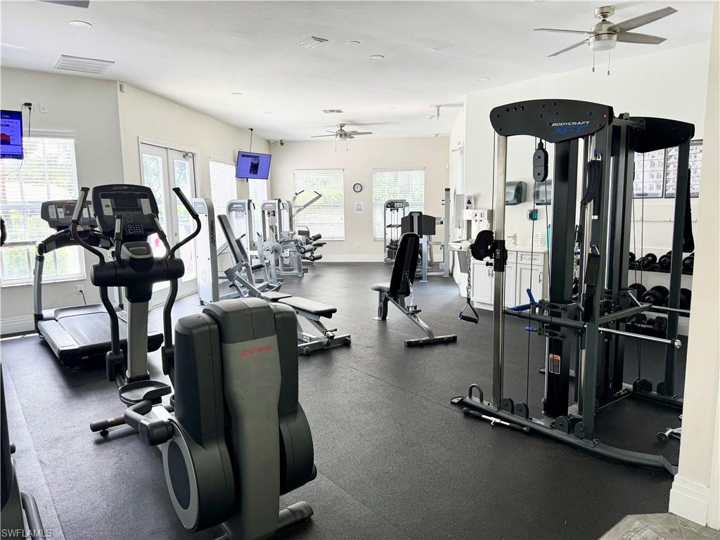 7057 Timberland Circle Naples, FL 34109 - Photo 17 of 22 a view of a room with gym equipment