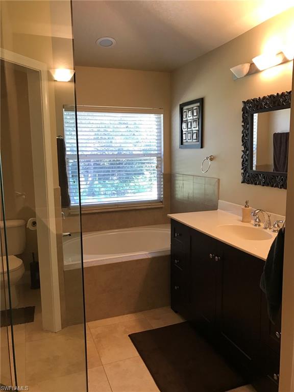 7057 Timberland Circle Naples, FL 34109 - Photo 7 of 22 a bathroom with a sink and a mirror