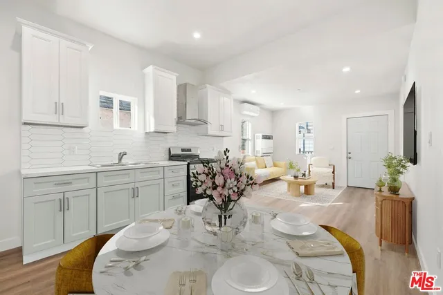 a living room with kitchen island furniture and a chandelier