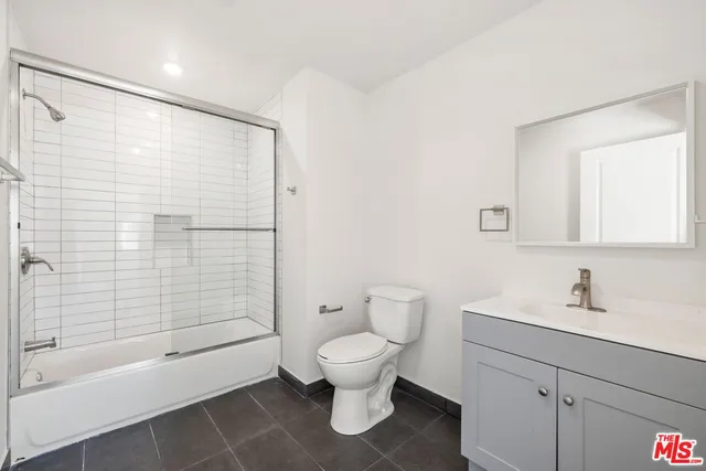 a bathroom with a toilet sink and shower