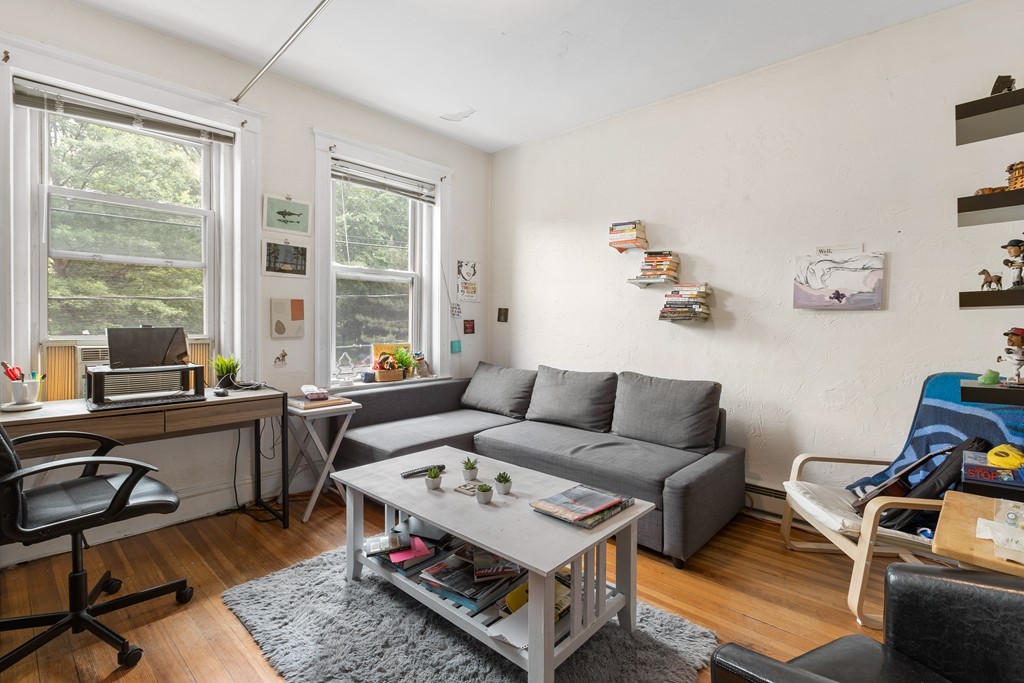 316 Summit Avenue, Unit 6 Boston, MA 02135 - Photo 2 of 9 a living room with furniture a rug and a large window