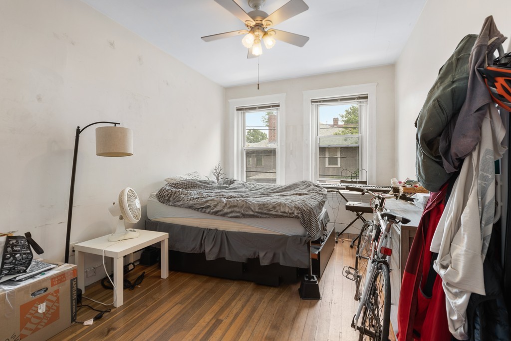 316 Summit Avenue, Unit 6 Boston, MA 02135 - Photo 6 of 9 a bed room with a bed and a chandelier