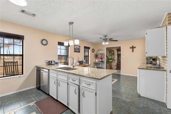 a kitchen with stainless steel appliances granite countertop a sink and a stove
