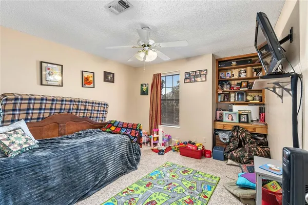a bedroom with furniture and a flat screen tv