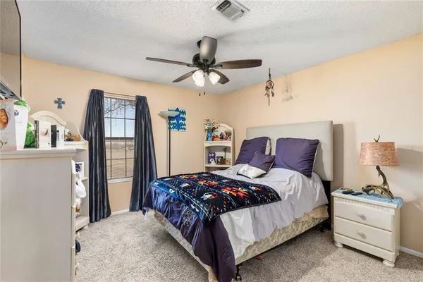 a bedroom with a bed dresser and a window