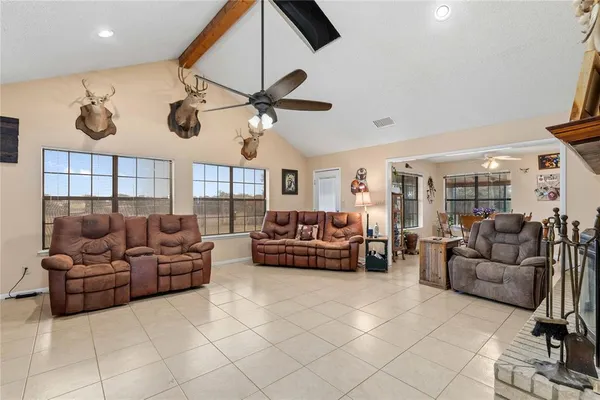 a living room with furniture and a ceiling fan