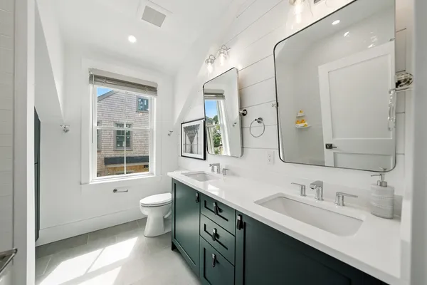 a bathroom with a sink double vanity and a toilet