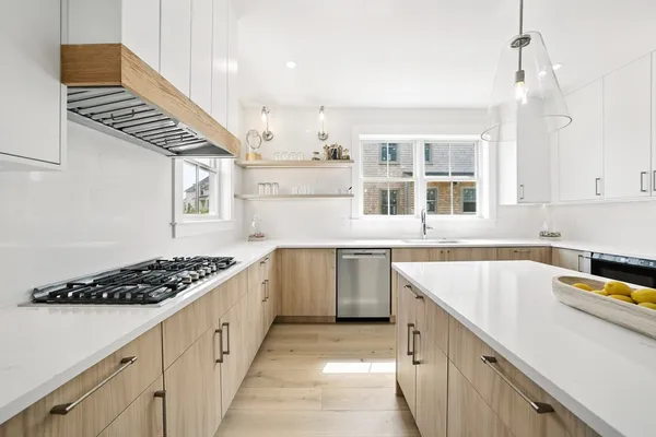 a kitchen with stainless steel appliances sink stove and cabinets