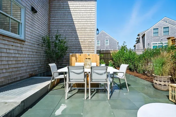 a view of a patio with table and chairs and potted plants