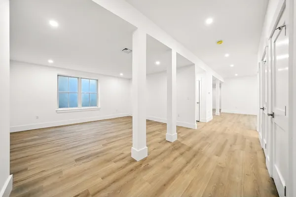 a view of an empty room and wooden floor