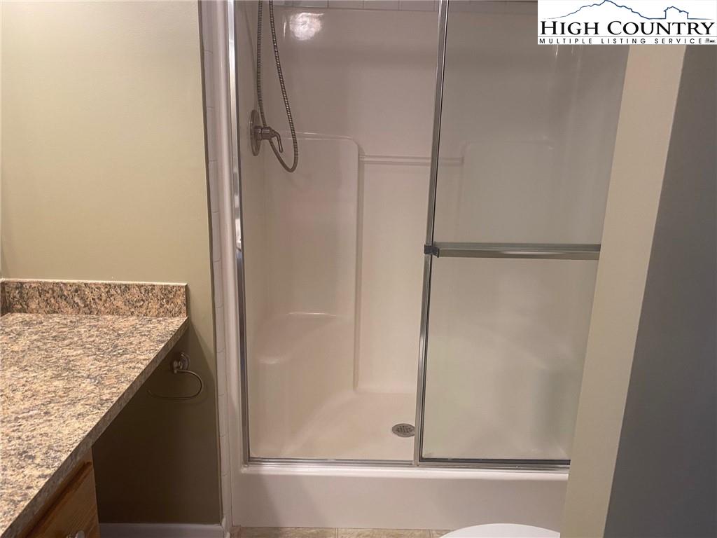 125 Moxley Ridge Road Sparta, NC 28675 - Photo 8 of 30 a bathroom with a granite countertop shower and a sink