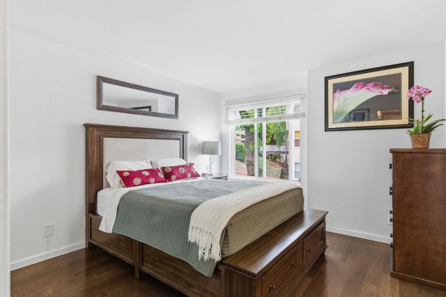 673 Royston Lane, Unit 233 Hayward, CA 94544 - Photo 20 of 32 a bedroom with a bed and wooden floor