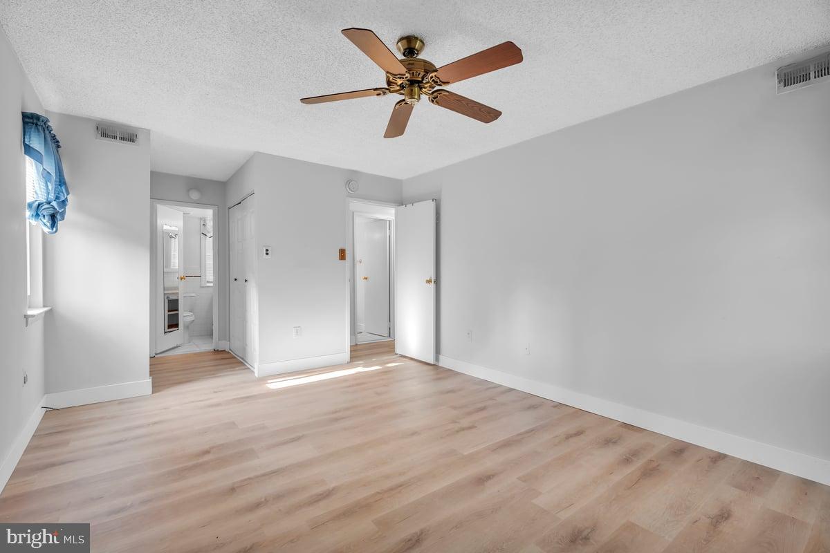 223 James Marlton, NJ 08053 - Photo 15 of 28 a view of an empty room with window a ceiling fan and wooden floor