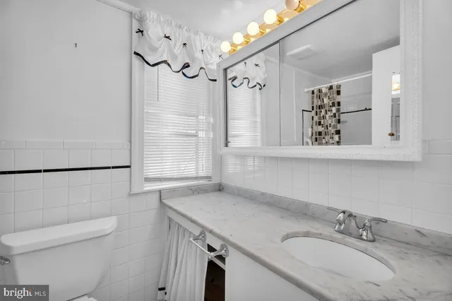 a bathroom with a sink a vanity and a mirror