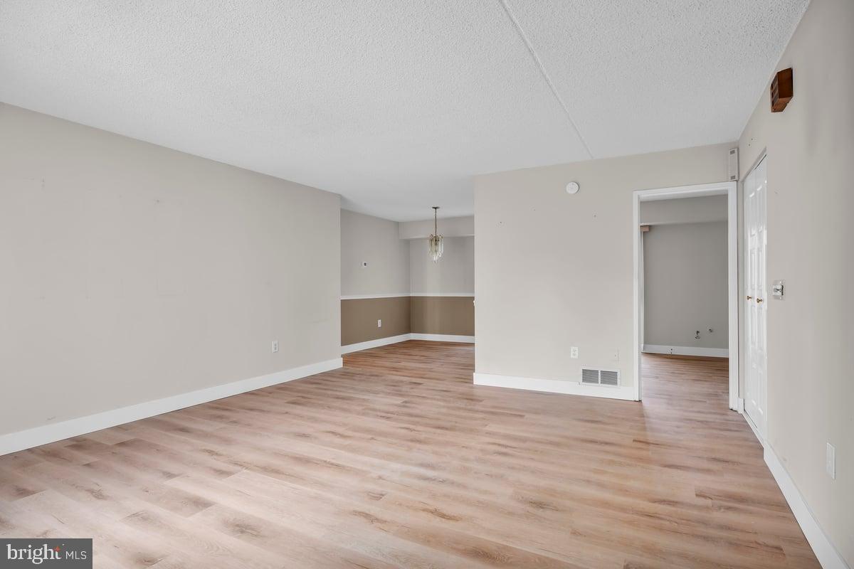 223 James Marlton, NJ 08053 - Photo 6 of 28 a view of an empty room with wooden floor and a window