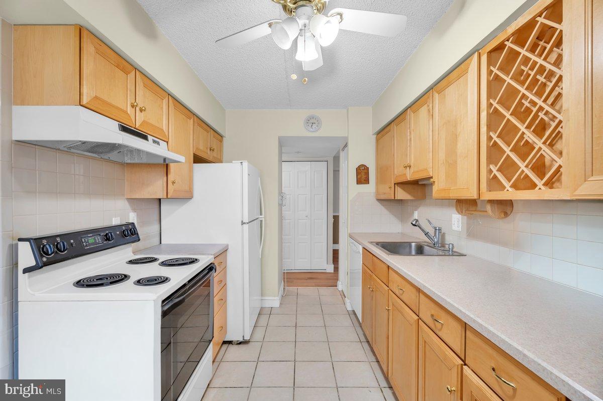 223 James Marlton, NJ 08053 - Photo 9 of 28 a kitchen with stainless steel appliances a sink a stove a refrigerator cabinets and a dining table